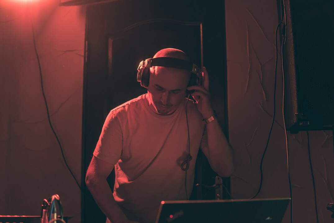 Producer wearing a headset directing a live broadcast from a control desk