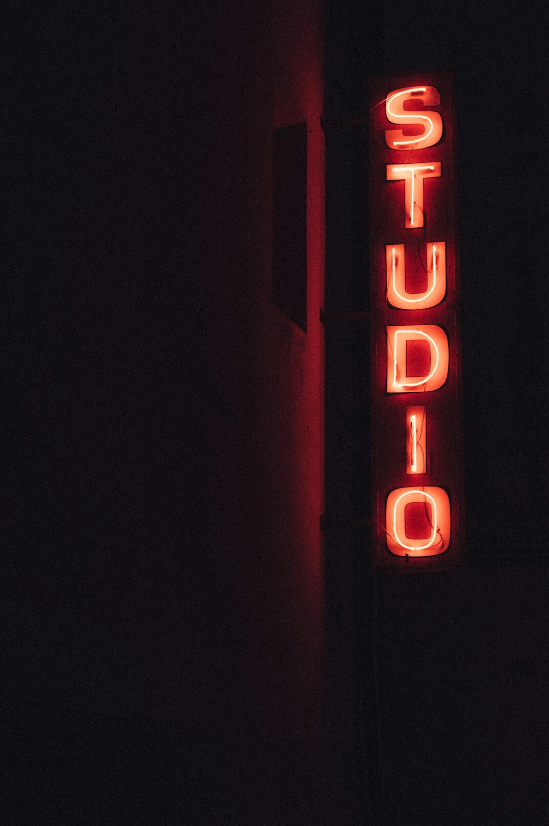 Security and studio staff briefing near television studio entrance