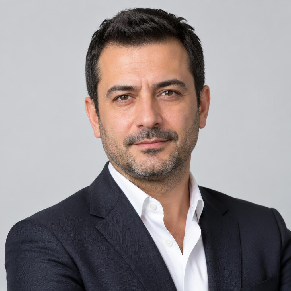 Portrait of a Turkish man in a suit smiling at camera